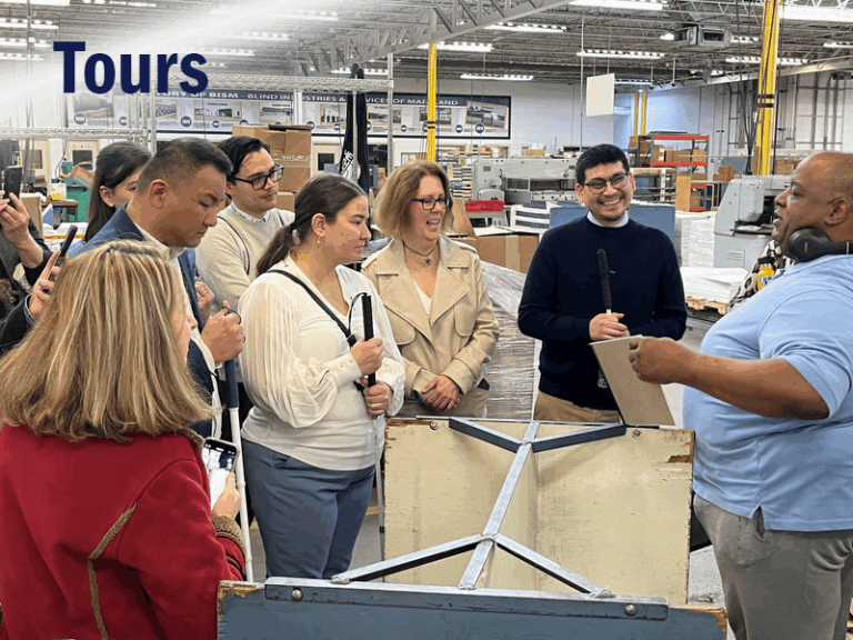Group of blind and low vision people receiving a tour of BISM facilities