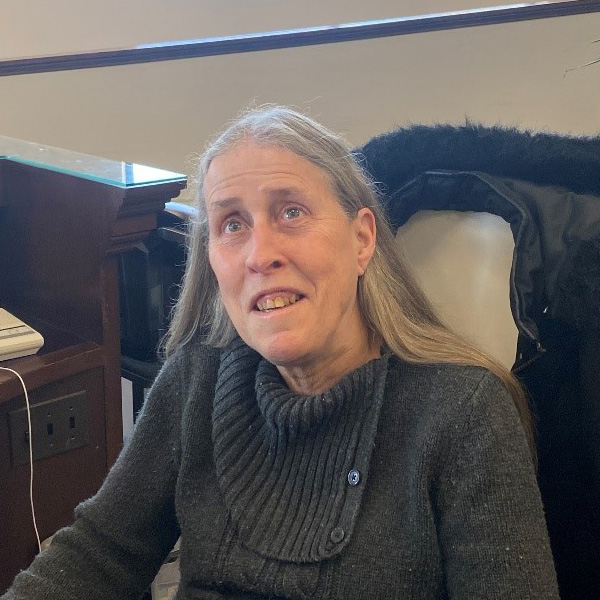 Director of First Impressions, Ruth Hairsine, sits at BISM reception desk