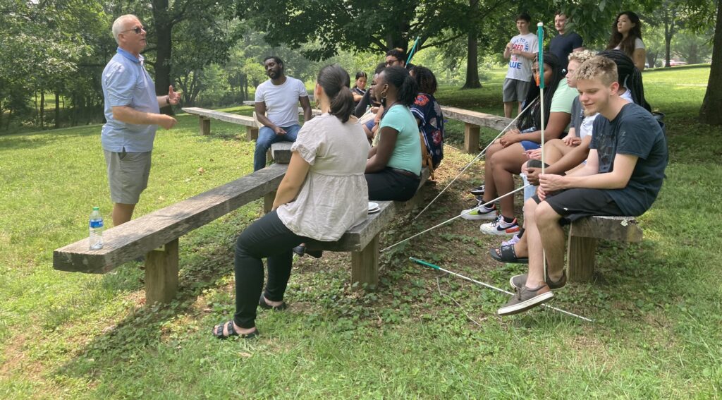 Group of students at a picnic table learning about nature