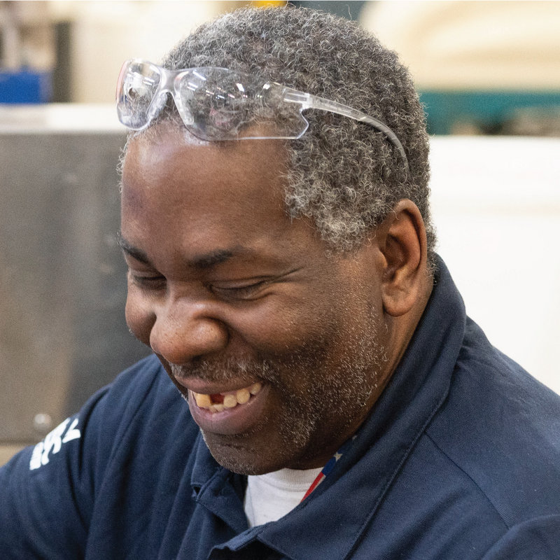 Linwood smiles while wearing his safety glasses on top of his head