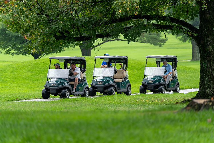 Photo of 3 golf carts driving along the Suburban golf course last year