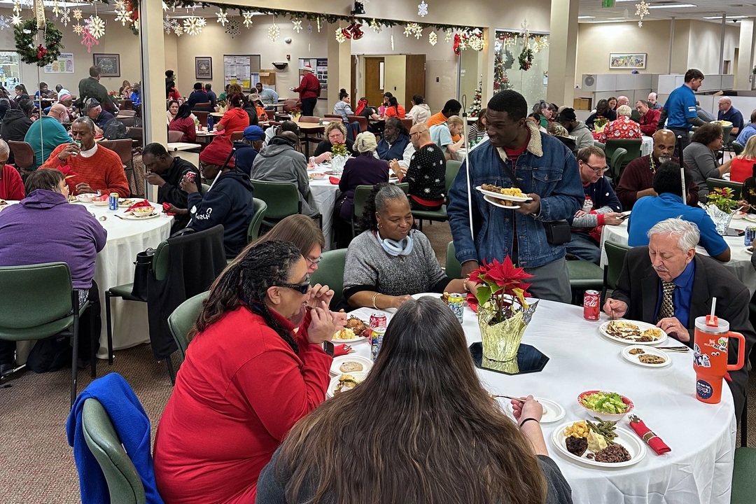 Associates eating at tables at Baltimore Holiday Party