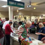 Baltimore holiday party - Senior leadership serving Associates lunch.