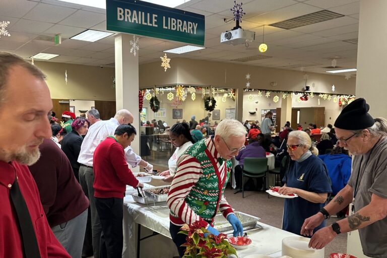 Baltimore holiday party - Senior leadership serving Associates lunch.
